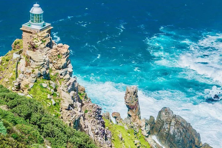 The lighthouse on its cliff above turquoise surf