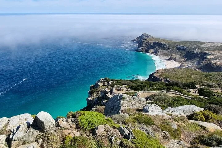 A turquoise bay below the cliffs near the point